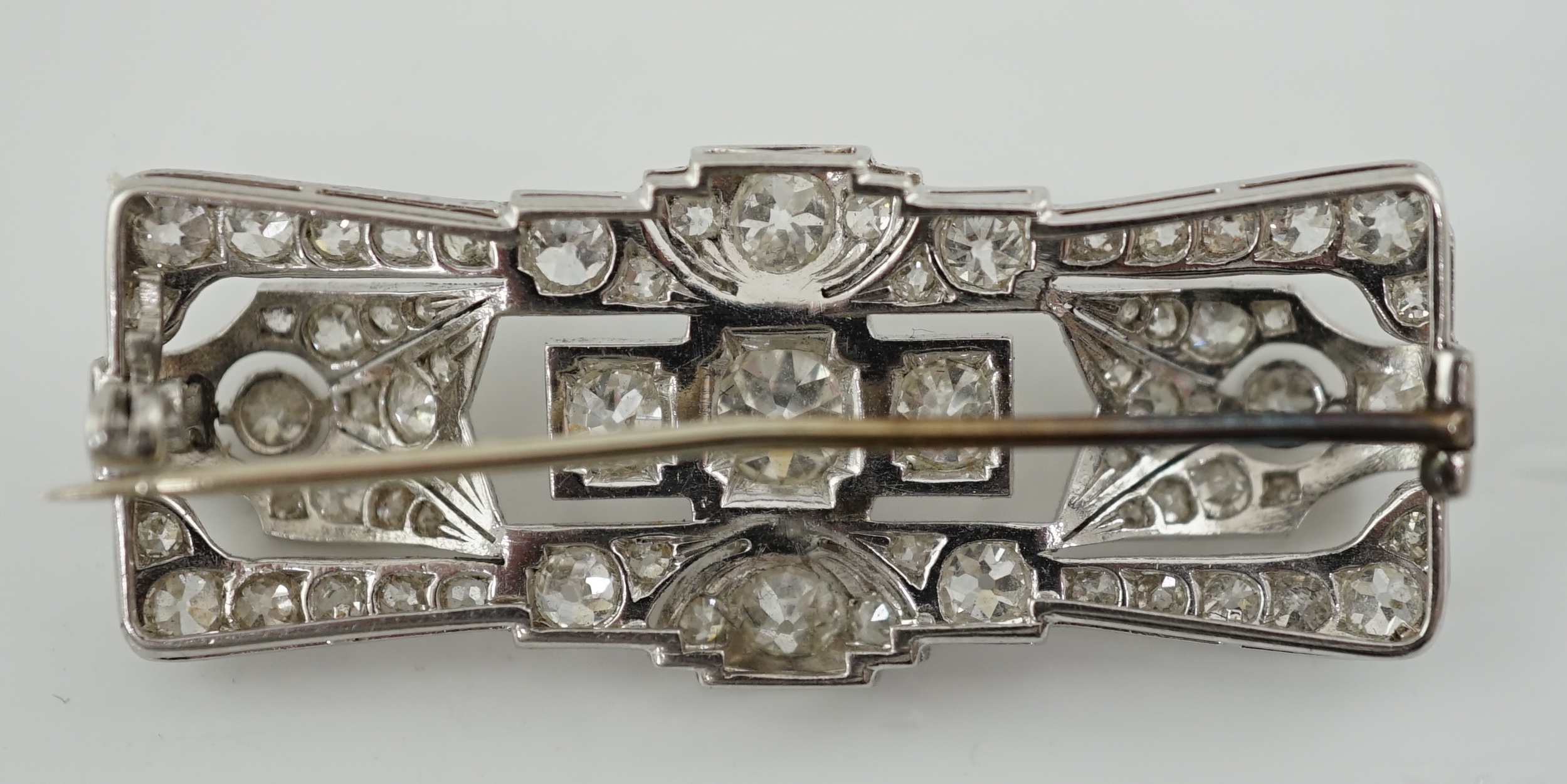 An Art Deco platinum and millegrain set diamond cluster brooch